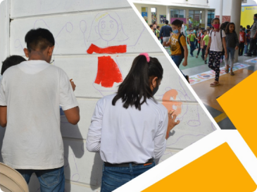 A girl and boy drawing a paint on school wall