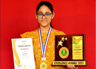 Girl get award and certificate for getting hundred percent result