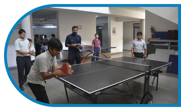 A boy play tabble tennis at anand niketan school